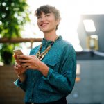 Types of Loans - picture of happy girl on iphone - we buy nky houses