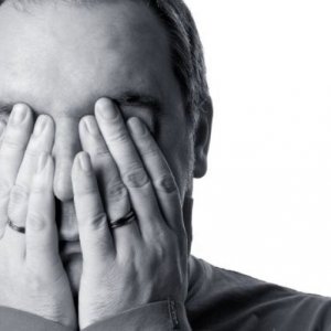 Sell a Houston Investment Property Fast. Man With hands over face.