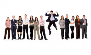 business man jumping with his business team formed of young businessmen and businesswomen standing over a white background with reflections